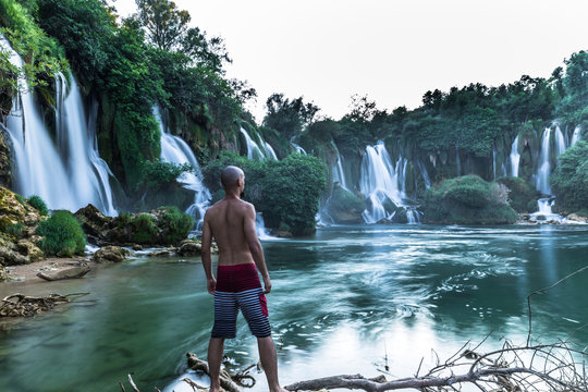 July 12, 2016: A tourist enjoying the Kravica Waterfalls, Bosnia