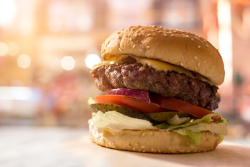Burger with sesame seeds. Grilled cheese and meat. Fast food cafe commercial.