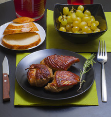 meat with rosemary on a decorated table