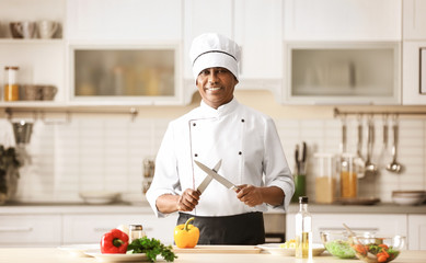 Mature Indian chef cooking in kitchen