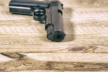 solitary gun  on wooden background
