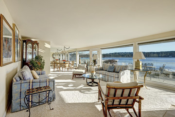 Cozy light filled family room with a wall of windows