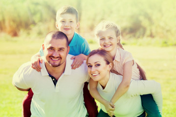 Fototapeta premium Joyful parents with children outdoor.