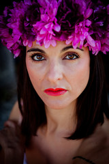 Beautiful Young Woman with Pink Flowers in the Hair