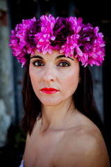 Naklejka premium Beautiful Young Woman with Pink Flowers in the Hair