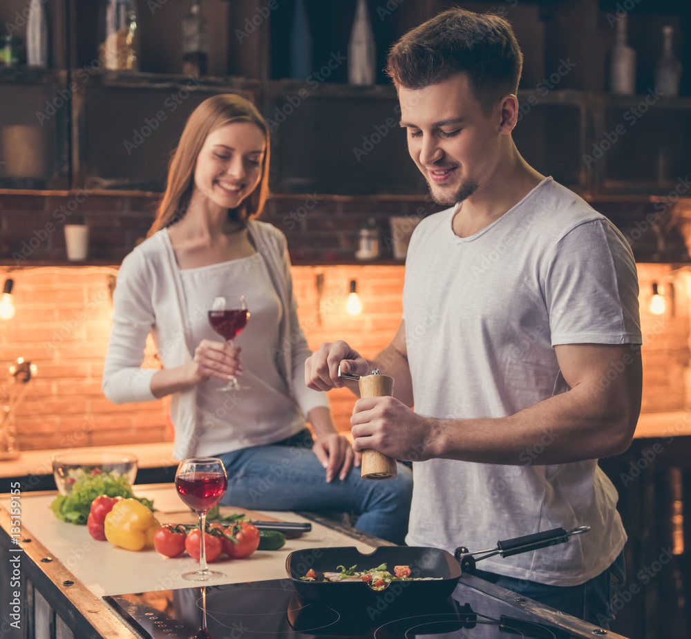 Wall mural beautiful couple cooking