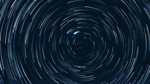 Starry sky time lapse with the star trails like comets. North Pole Star (Alpha Ursae Minoris) is in the center.