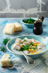 Homemade soup with chicken meat, corn, potatoes and parsley leaves in ceramic bowl. Simple stew. Selective focus.