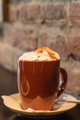 Coffe with whiped cream for breakfast with croissant in cafe