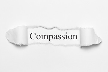 Compassion on white torn paper