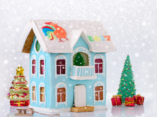 new year gingerbread two story house with balcony homemade and bokeh, snow