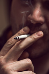 Obraz premium Closeup of young caucasian man smoking