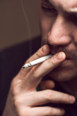 Young caucasian man smoking cigarette