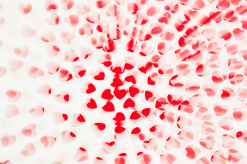 Valentine's day  decorative soft blur abstract pattern of red hearts confetti  on white background. Festive valentine backdrop.