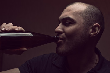 Young drunk man with beer bottle