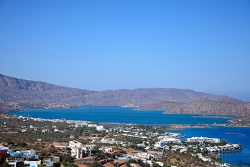 Elevated view of Elounda with views across the sea towards the island of Spinalonga on the right hand side, Elounda, Crete.