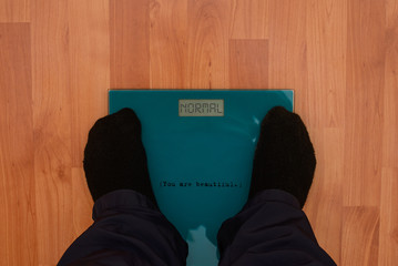 Normal man or a woman on scales