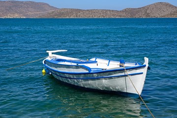 Fototapeta premium Small fishing boat moored in the bay, Elounda, Crete.