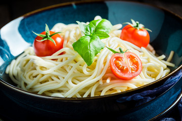 Fresh spaghetti with basil, tomatoes and parmesan