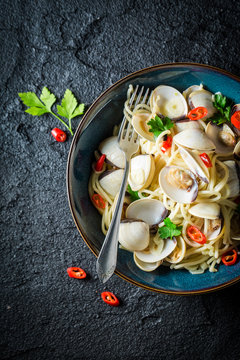 Tasty seafood pasta with clams, parsley and peppers