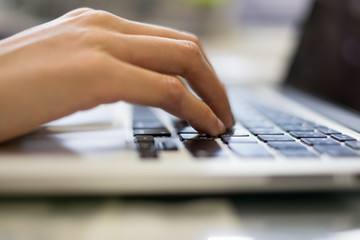 Hand of businessman typing on laptop keyboard
