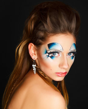 Beauty portrait of a young girl with bright blue makeup. Art bea