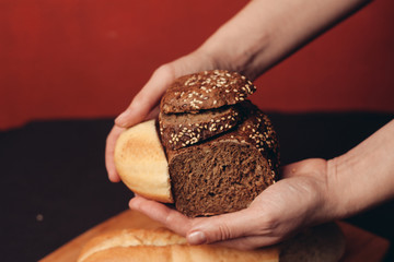 gray and white bread in hand, red background