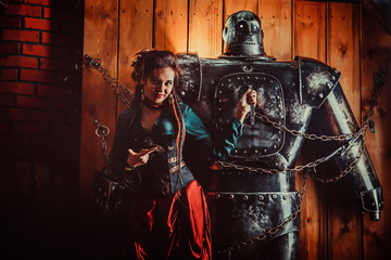 A beautiful woman with the tied male robot.