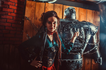 Naklejka na ściany i meble A beautiful woman with the tied male robot.
