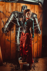 A beautiful woman with the tied male robot.