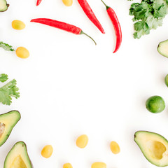 Frame made of raw food ingredients of guacamole: avocado, chili pepper, coriander, cherry tomato, lime. Flat lay, top view. Food concept.