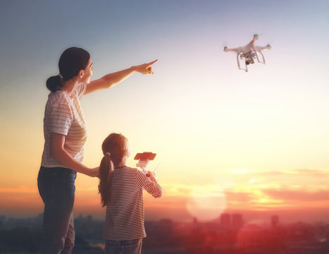 Kid and mom playing with drone