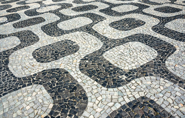 Black and white iconic mosaic, Portuguese pavement by old design pattern at Ipanema beach, Rio de Janeiro, Brazil