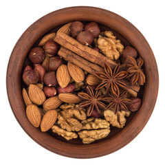 Mixture of nuts in a brown plate. Isolated on white background.