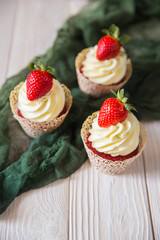Muffins red velvet with cheese cream and strawberry