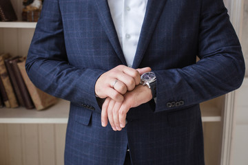 Obraz na płótnie Canvas Man in blue suit, check your time, business, success. Selective focus