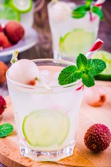 Cold fresh lemonade with lychee, lime and mint in glass