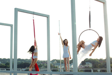 Beautiful girls  performing pole, aerial and hoop dance on roof
