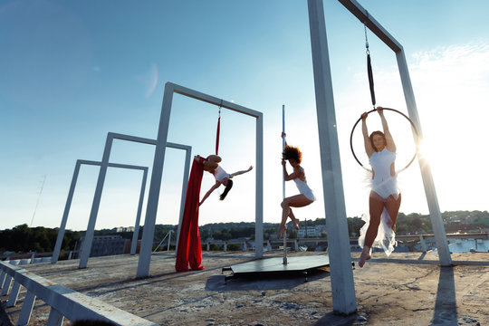 Beautiful girls  performing pole, aerial and hoop dance on roof