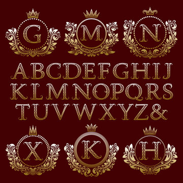 Vintage monogram kit. Starry gold letters and floral coat of arms frames for creating initial logo in antique style.