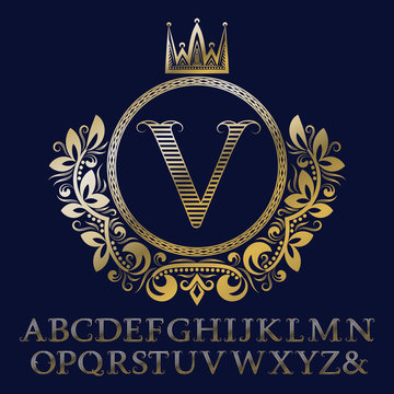Striped gold letters and initial monogram in coat of arms form with crown. Royal font and elements kit for logo design.