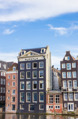Fototapeta premium Traditional houses at the Damrak in Amsterdam