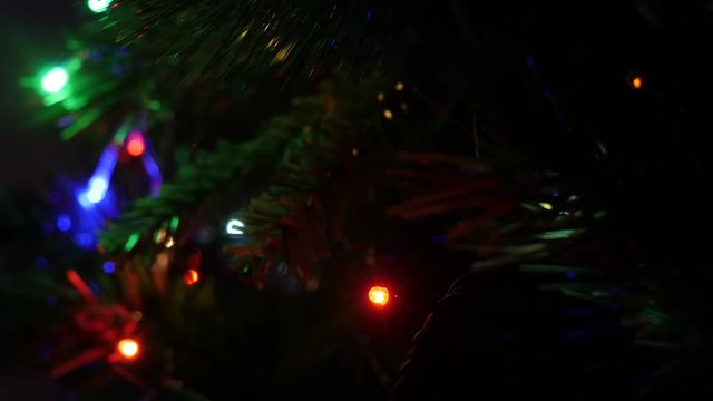Christmas fairy lights sequence on artificial tree 4K 2160p 30fps UltraHD footage - Blinking decorative bulbs on New Year night close-up 3840X2160 UHD video 