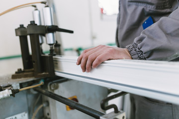 Manual worker assembling PVC doors and windows. Manufacturing jobs. Selective focus. Factory for aluminum and PVC windows and doors production.