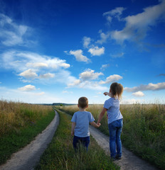 little boy and girl in the field
