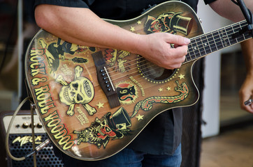 Acoustic guitar covered in stickers