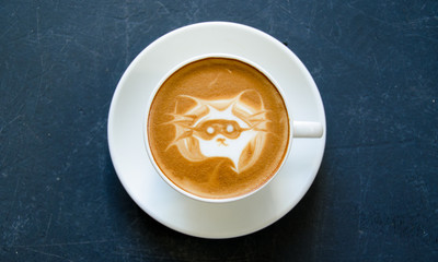 Coffee with masked animal drawn onto froth