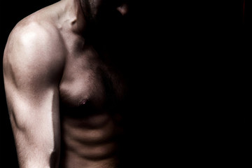 Naklejka premium Strong athletic man on black