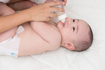 Obraz na płótnie Canvas Adorable baby drinking milk