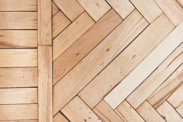 Close top view on rich texture of old brushed and distressed wooden parquet floor made from many...